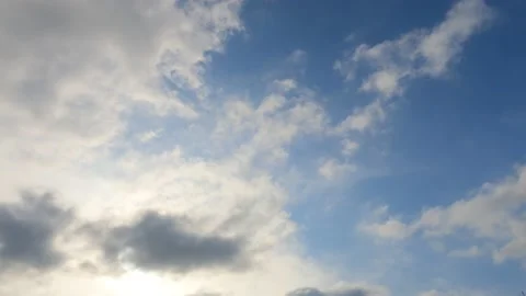 Bright sun light ray n sunbeam break through fast moving white n gray cloud Stock Footage 147071466