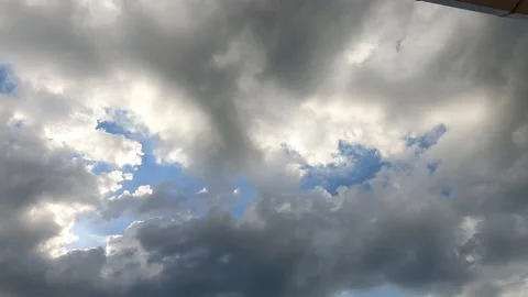 Bright sun light ray n sunbeam break through fast moving white n gray cloud Stock Footage 147071827
