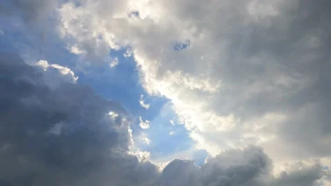 Bright sun light ray n sunbeam break through fast moving white n gray cloud Stock Footage 147071838
