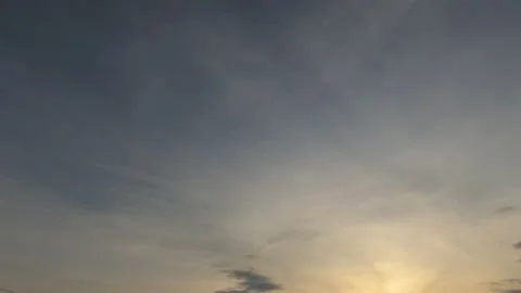 Bright sun light ray n sunbeam flare shining through dramatic golden gray clouds Stock Footage 147387086