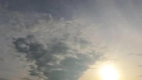 Bright sun light ray n sunbeam flare shining through dramatic golden gray cloud Video stock 147387533