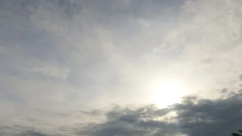 Bright sun light ray n sunbeam flare shining through dramatic golden gray clouds Stock Footage 147393504