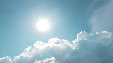 Bright sun light ray n sunbeam on sunny cyan blue sky with white clouds Video stock 165977395