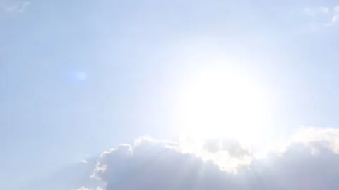 Bright sun light ray n bokeh sunlight lens flare through dark cloud on blue sky Video stock 262430215