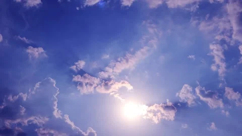 Bright sun light ray shine through rain storm cloud on clear navy blue sky Stock Footage 330095595