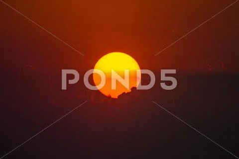 The bright sun in the puffy clouds, close up zoom view Stock Photos