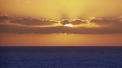 Bright Sun rays shine through the clouds over the azure Ocean Stock Footage 144227260