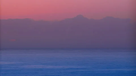 Bright Sun rays shine through the clouds over the azure Sea. Stock Footage 147506310