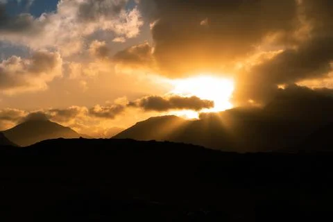 Bright sun rays through clouds Stock Photos