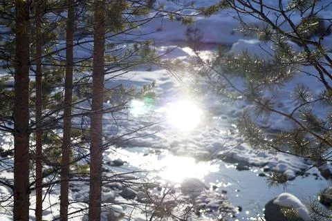 The bright sun is reflected in the mountain river Stock Photos