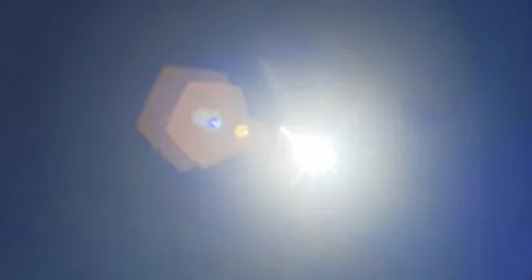 Bright sun shining in clear blue sky with realistic lens flare effect Stock Footage 341854121