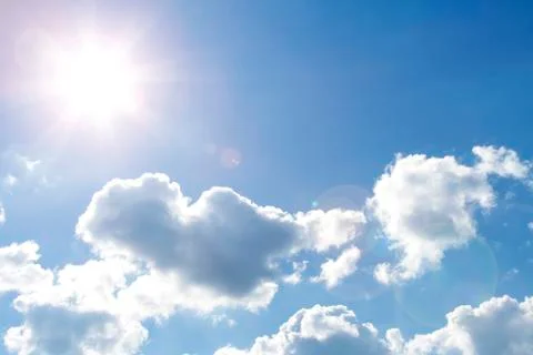 Bright sun shining in clouds Stock Photos