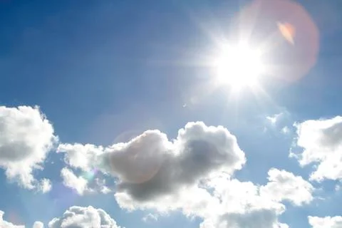 Bright sun shining in clouds Stock Photos