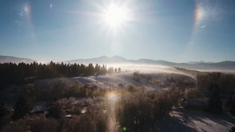 Bright sun shining over the snow covered landscape 動画素材 91982243