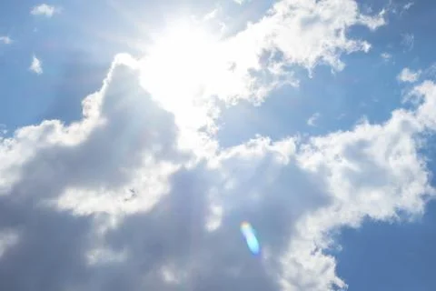 Bright Sun Shining Through Clouds in Blue Sky Stock Photos
