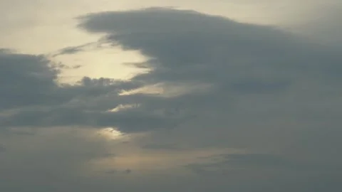 Bright sun shining through dark dramatic clouds over tree silhouettes Stock Footage 338201498