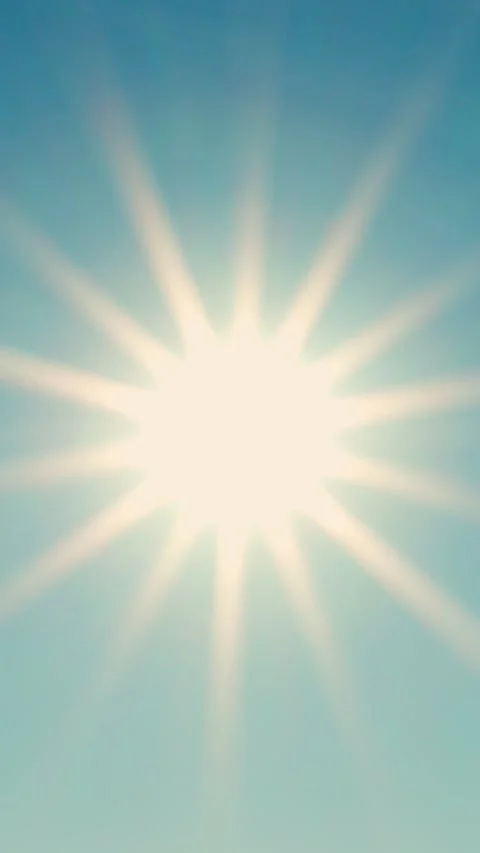 Bright sun with sun rays in a blue sky. Close-up of sunlight. Video stock 319496744