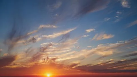 Bright sun at sunset with thin wispy clouds in the sky. Natural landscape v.. Stock Photos