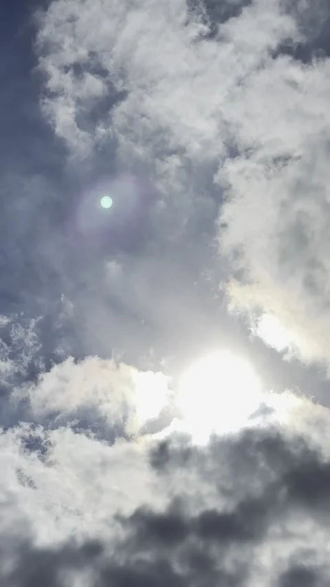 Bright Sun Surrounded by Dramatic Clouds Видео 344883610
