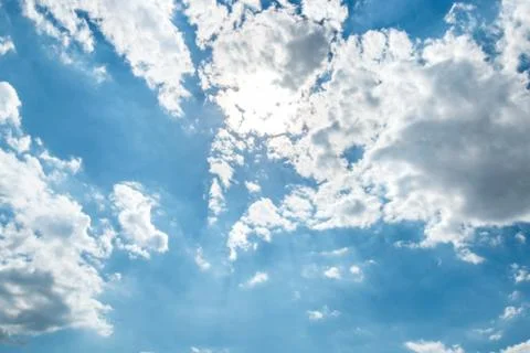 Bright sun, White heap clouds and bright sun in the blue sky. Stock Photos