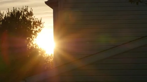 Bright sunburst around the corner of a building at dawn Stock Footage 152360071