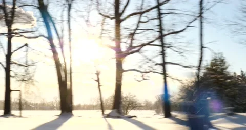 Bright sunburst over a house in winter during drive Stock Footage 171908236