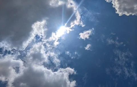 Bright Sunlight Breaking Through Dramatic Clouds in Blue Sky 스톡 사진