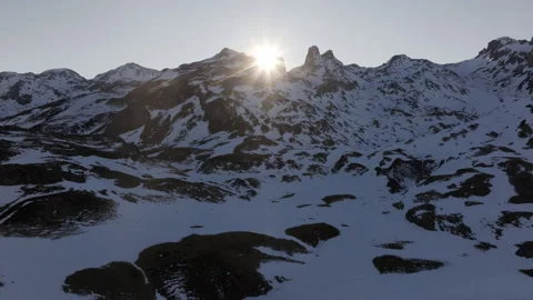 Bright sunlight casting dramatic shadows on snow blanketed Pyrenees mountain Stock Footage 306707863