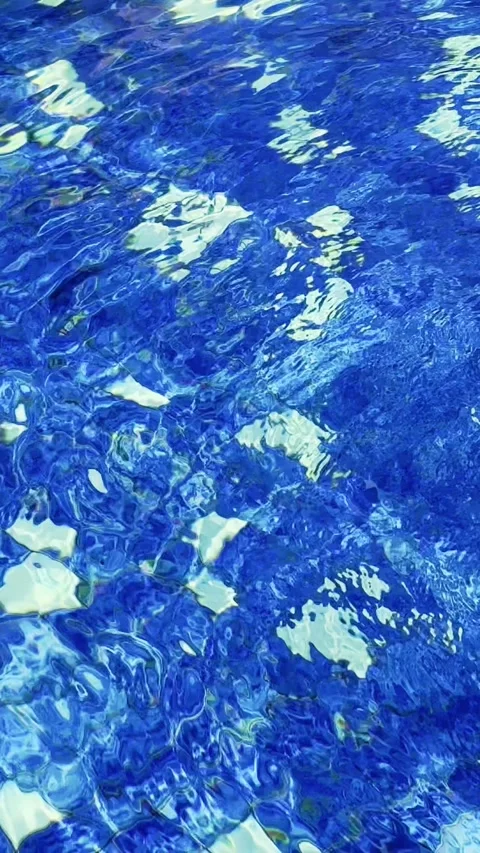 Bright sunlight creates shimmering abstract reflections across clear blue s.. Stock Footage 340115977