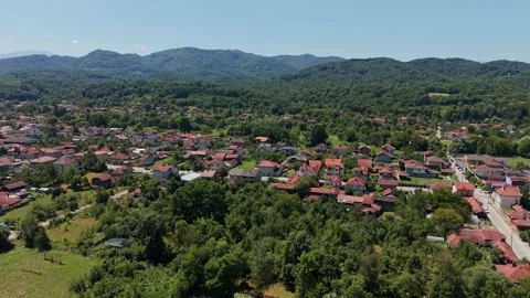 Bright sunlight over red rooftops and green trees in Bulgaria Stock-Footage 344628578