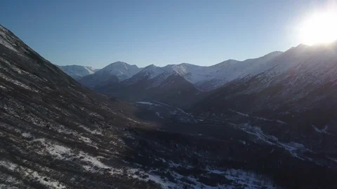 Bright sunlight over the snow clad mountain ranges Stock Footage 104569110