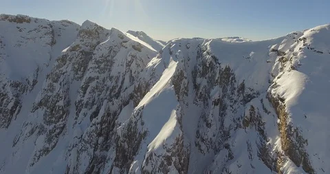 Bright sunlight over the snow covered mountains Stock Footage 108636657