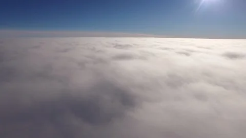 Bright sunlight over the white fluffy clouds Stock Footage 104223086