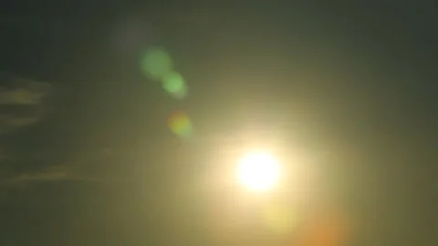 Bright sunlight rays flare and sunbeams shine through colorful dark cumulus c Stock Footage 222784744