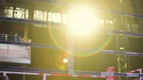 Bright sunlight shines through a boxing ring at an indoor arena during an Stock Footage 302490925