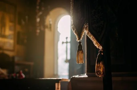 Bright sunlight streams through the windows of the Orthodox church. The con.. Stock Photos