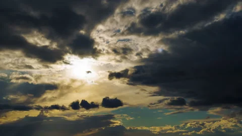 Bright sunlight through a dark dramatic sky with thunderclouds, extreme weather Video stock 179368839