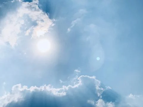 Bright Sunlight Through Soft Clouds in a Blue Atmospheric Sky Stock Photos