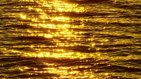 Bright sunlit reflections create a golden ocean surface. Stock Footage 308055085