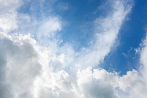 Bright sunny day with clouds. Cloudscape on blue sky. Soft focus. Stock Photos