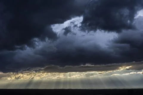 Bright sunrays cut through ominous clouds hovering over midtown Atlanta Stock Photos
