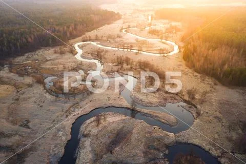 Bright sunrise over wild curved river aerial view Stock Photos
