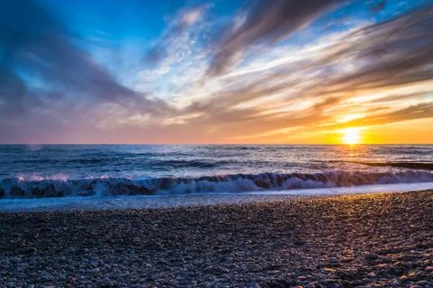 Bright Sunset and Waves Stock Photos
