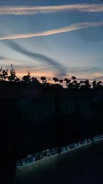 Bright sunset casts colors over the bustling city below Stock Photos