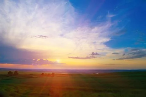 Bright sunset in cloudy sky Stock Photos