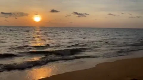 Bright sunset light reflects on the sea waves' surface Stock Footage 196979120