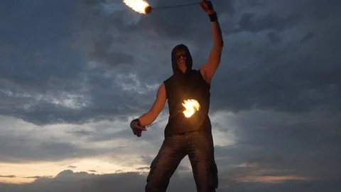 Bright sunset, the man with the fire is on the mountain. Fire-show. Stock Footage 88307583