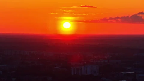 Bright Sunset Over Distant City Skyline With Orange Sky Aerial Видео 333328243