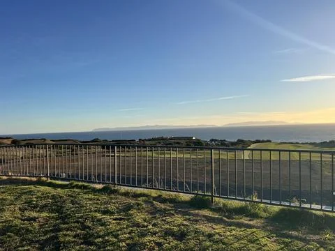 Bright Sunset Over the Ocean With a View From Grassy Hills Stock-Fotos