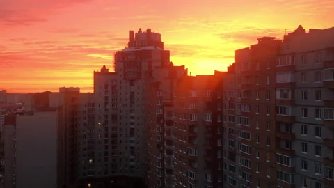 Bright sunset over the roofs of high-rise buildings in a residential area Stock Footage 207691712